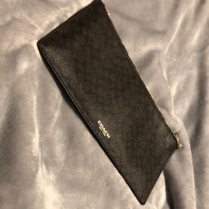 Coach holder, can be used for anything. My passport would not fit into it